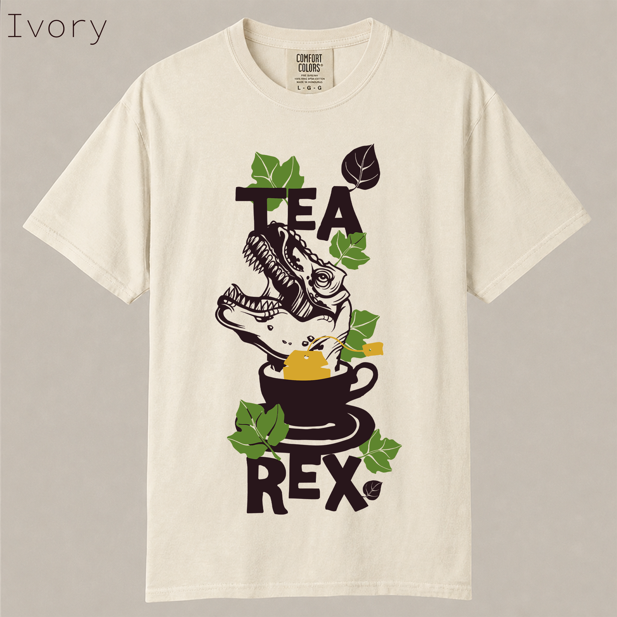 Funny Tea Rex dinosaur shirt. T-Rex in teacup with tea leaves graphic, hilarious tea pun tee for dinosaur and tea lovers on soft garment-dyed cotton.